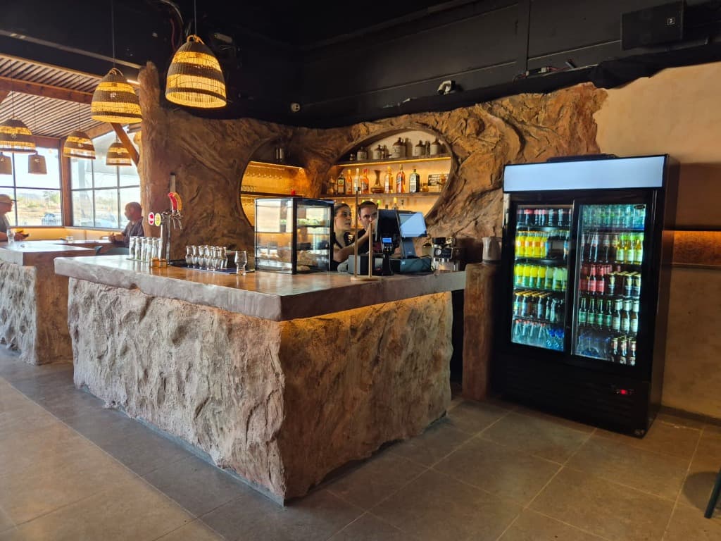 Water bottle on the stone counter with the restaurant bar in the background